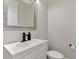 A half bathroom with a modern vanity and a sleek black faucet, offering convenience and style at 4500 Chinkapin Dr, Sarasota, FL 34232