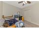 A cozy bedroom with carpet, a ceiling fan, and a wooden bed frame for a comfortable rest at 4500 Chinkapin Dr, Sarasota, FL 34232