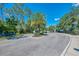 Gated community entrance with lush landscaping and a well-maintained road leading to secure access at 4500 Chinkapin Dr, Sarasota, FL 34232