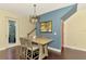 Comfortable dining room with a modern table, stylish light fixture, and access to the patio at 4500 Chinkapin Dr, Sarasota, FL 34232