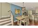Dining area with a rustic table, staircase, and an adjacent kitchen, ideal for entertaining at 4500 Chinkapin Dr, Sarasota, FL 34232