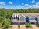A daytime aerial view of townhome and neighborhood, surrounded by lush greenery at 4500 Chinkapin Dr, Sarasota, FL 34232