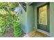 Charming front door framed by lush landscaping and exterior accents at 4500 Chinkapin Dr, Sarasota, FL 34232