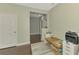 Hallway with hardwood floors, view to the living room and doorway to a bedroom at 4500 Chinkapin Dr, Sarasota, FL 34232
