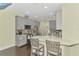 Modern kitchen featuring gray cabinets, quartz countertops, stainless steel appliances, and bar seating at 4500 Chinkapin Dr, Sarasota, FL 34232