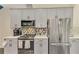 Updated kitchen features stainless appliances, grey cabinets, and stylish countertop at 4500 Chinkapin Dr, Sarasota, FL 34232