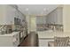 Well-equipped kitchen with gray cabinetry, stainless steel appliances, and stylish backsplash design at 4500 Chinkapin Dr, Sarasota, FL 34232