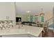 Bright, open kitchen with stone countertops, backsplash, and views of living and dining areas at 4500 Chinkapin Dr, Sarasota, FL 34232