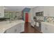 Open kitchen boasts stainless appliances, stone countertops, sleek grey cabinets, and a colorful backsplash at 4500 Chinkapin Dr, Sarasota, FL 34232