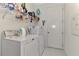 A functional laundry room with modern appliances, storage shelves, and tile flooring at 4500 Chinkapin Dr, Sarasota, FL 34232