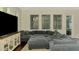 Comfortable living room featuring a large sectional sofa and entertainment center at 4500 Chinkapin Dr, Sarasota, FL 34232