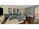 Cozy living room featuring a plush oversized sectional sofa, hardwood floors, and natural light at 4500 Chinkapin Dr, Sarasota, FL 34232