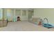 Open floor plan living room with neutral carpet and view to the windows at 4500 Chinkapin Dr, Sarasota, FL 34232