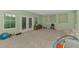Bright living room with carpet, access to the balcony and windows at 4500 Chinkapin Dr, Sarasota, FL 34232