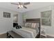 Light-filled main bedroom with a ceiling fan, wood floors and ensuite bathroom at 4500 Chinkapin Dr, Sarasota, FL 34232