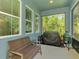 Screened patio with comfortable seating and views of the natural landscape, perfect for relaxation and grilling at 4500 Chinkapin Dr, Sarasota, FL 34232