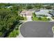 Aerial view of a home nestled on a cul-de-sac with a manicured lawn and mature landscaping at 4804 Jacaranda Heights Dr, Venice, FL 34293
