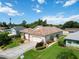 Aerial view of the home showcasing its tile roof, well-manicured lawn, and landscaping at 4804 Jacaranda Heights Dr, Venice, FL 34293