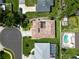 Bird's eye view of a home with a distinct tile roof, surrounded by manicured lawns and a neatly paved driveway at 4804 Jacaranda Heights Dr, Venice, FL 34293