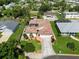 Stunning aerial view of a home featuring a beautiful tile roof, landscaped yard, and a private driveway at 4804 Jacaranda Heights Dr, Venice, FL 34293