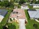 A high angle view of a home with a unique tile roof and well-kept landscaping, captured in the sunshine at 4804 Jacaranda Heights Dr, Venice, FL 34293