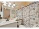 Bathroom featuring a vanity, commode, and nautical-themed shower curtain at 4804 Jacaranda Heights Dr, Venice, FL 34293