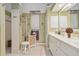 Light and airy bathroom with decorative accents, vanity, and walk-in shower at 4804 Jacaranda Heights Dr, Venice, FL 34293