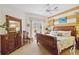 This bedroom features a dresser, light-filled windows, and a comfortable bed at 4804 Jacaranda Heights Dr, Venice, FL 34293