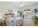 Serene bedroom featuring a coastal-themed bed, a seating area, and French doors to a private patio at 4804 Jacaranda Heights Dr, Venice, FL 34293