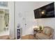 Cozy bedroom features a sitting area, decor, and a mounted television at 4804 Jacaranda Heights Dr, Venice, FL 34293