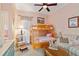 This cozy bedroom offers a bunk bed, a sofa, and thoughtful decor creating a comfortable retreat at 4804 Jacaranda Heights Dr, Venice, FL 34293