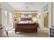Bright bedroom with a ceiling fan, striped accent wall, and access to outdoor area at 4804 Jacaranda Heights Dr, Venice, FL 34293