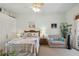 This bedroom boasts coastal decor, a comfortable chair, and serene light, creating a calming space at 4804 Jacaranda Heights Dr, Venice, FL 34293