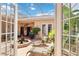 Enclosed courtyard with a covered patio, a fountain, lounge chairs, and ample space for entertaining at 4804 Jacaranda Heights Dr, Venice, FL 34293