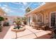 Spacious outdoor courtyard featuring comfortable seating, charming fountain, and lovely patio space at 4804 Jacaranda Heights Dr, Venice, FL 34293