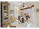 Bright dining area with modern furniture, and large windows overlooking the backyard and patio at 4804 Jacaranda Heights Dr, Venice, FL 34293