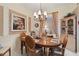 Formal dining room with an elegant chandelier and traditional wooden furniture at 4804 Jacaranda Heights Dr, Venice, FL 34293