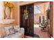 Welcoming entryway leading to a screened patio, with comfortable bench and decorative floral arrangement at 4804 Jacaranda Heights Dr, Venice, FL 34293