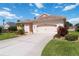 Beautifully landscaped home featuring a pristine driveway and lush green lawn at 4804 Jacaranda Heights Dr, Venice, FL 34293