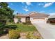 Charming single-story home with a well-manicured lawn and beautiful landscaping at 4804 Jacaranda Heights Dr, Venice, FL 34293