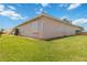 Exterior view of the home showing the well-maintained lawn, siding, and white shutters at 4804 Jacaranda Heights Dr, Venice, FL 34293