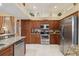 Well-equipped kitchen featuring stainless steel appliances, granite countertops, and ample cabinet space at 4804 Jacaranda Heights Dr, Venice, FL 34293