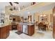 Open-concept kitchen featuring granite countertops, stainless steel appliances, and a breakfast bar overlooking dining area at 4804 Jacaranda Heights Dr, Venice, FL 34293