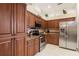 Well-equipped kitchen featuring stainless steel appliances, granite countertops, and ample cabinet space at 4804 Jacaranda Heights Dr, Venice, FL 34293