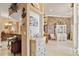 Open-concept living space featuring decorative furniture, tiled floors, and stone accent wall at 4804 Jacaranda Heights Dr, Venice, FL 34293