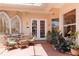 Charming patio features a dining set, tiled flooring, ceiling fan, and lush greenery at 4804 Jacaranda Heights Dr, Venice, FL 34293