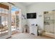 Bright sunroom with TV, wet bar, and French door access to the pool at 4804 Jacaranda Heights Dr, Venice, FL 34293