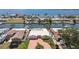 Aerial shot of neighborhood showcasing waterfront property with canal access and boat docks on a sunny day with ocean view at 4829 Commonwealth Rd, Palmetto, FL 34221