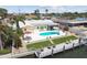 Aerial shot showcases a home's pool, waterfront access, and dock on a sunny day, perfect for outdoor activities at 4829 Commonwealth Rd, Palmetto, FL 34221