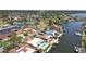 Aerial view featuring waterfront homes along a canal with private docks, convenient access to the bay, and mature trees at 4829 Commonwealth Rd, Palmetto, FL 34221